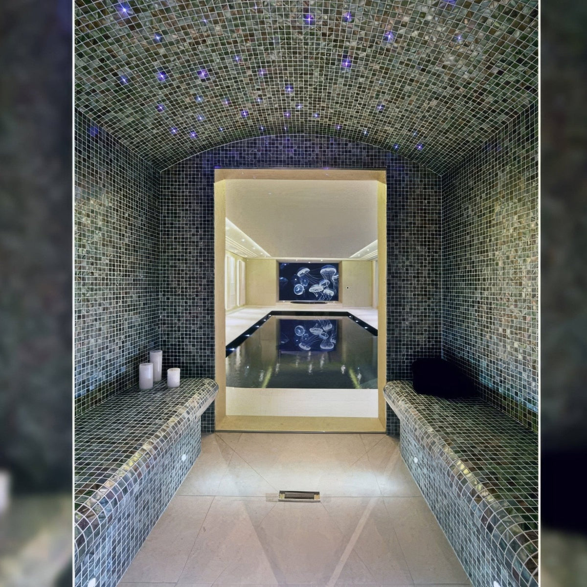 Anthracite 25mm square dark blue mosaic tiles in a luxurious arched steam room with purple star-like lights