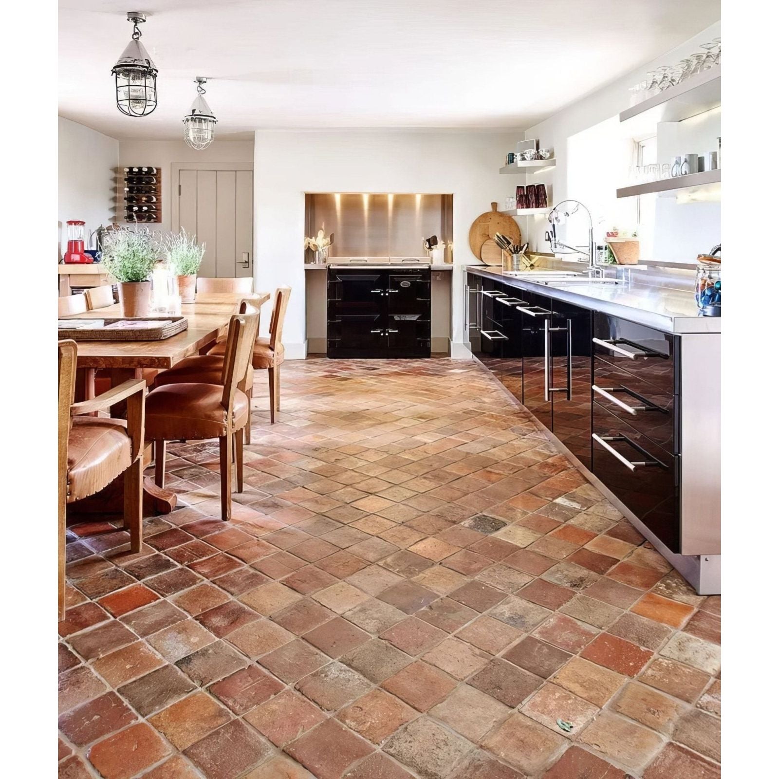 Antique burgundy terracotta reclaimed tile floor with rustic earthy pattern in warm reddish brown and beige tones