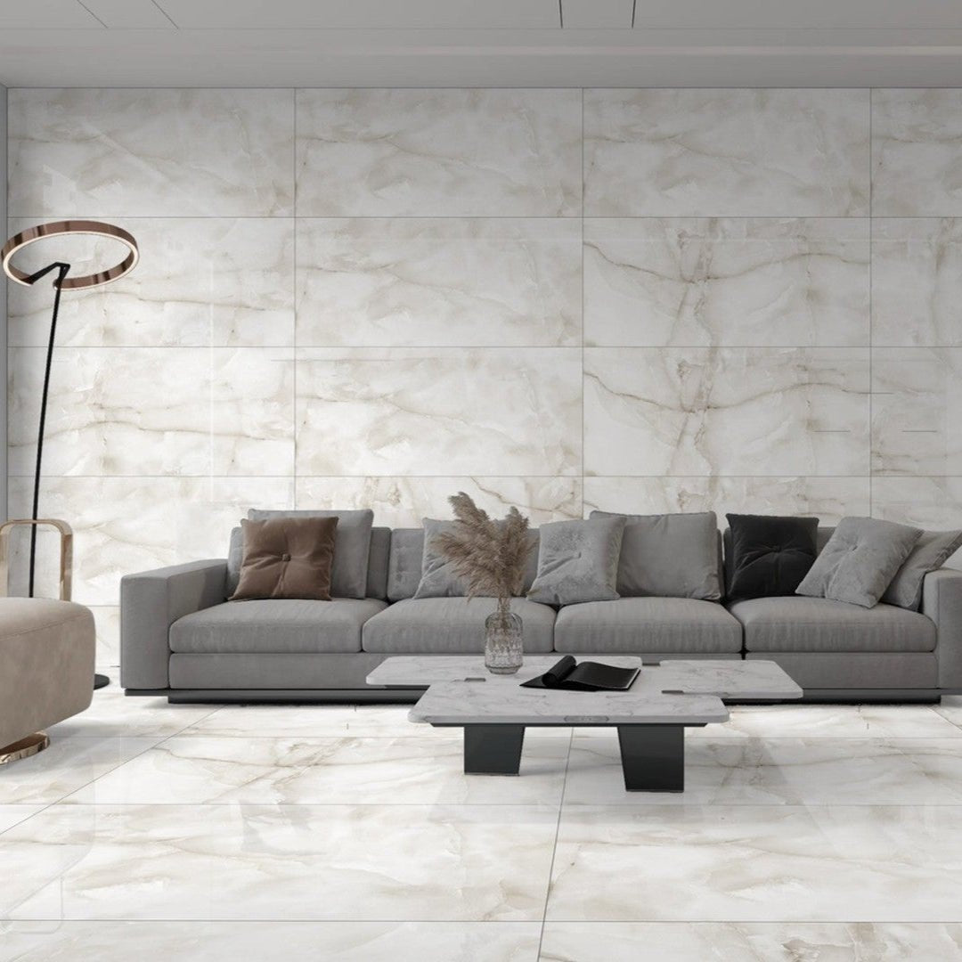 Aquarius Onyx Grey 60 x 120cm white and grey marble-effect tiles with a grey sectional sofa and coffee table