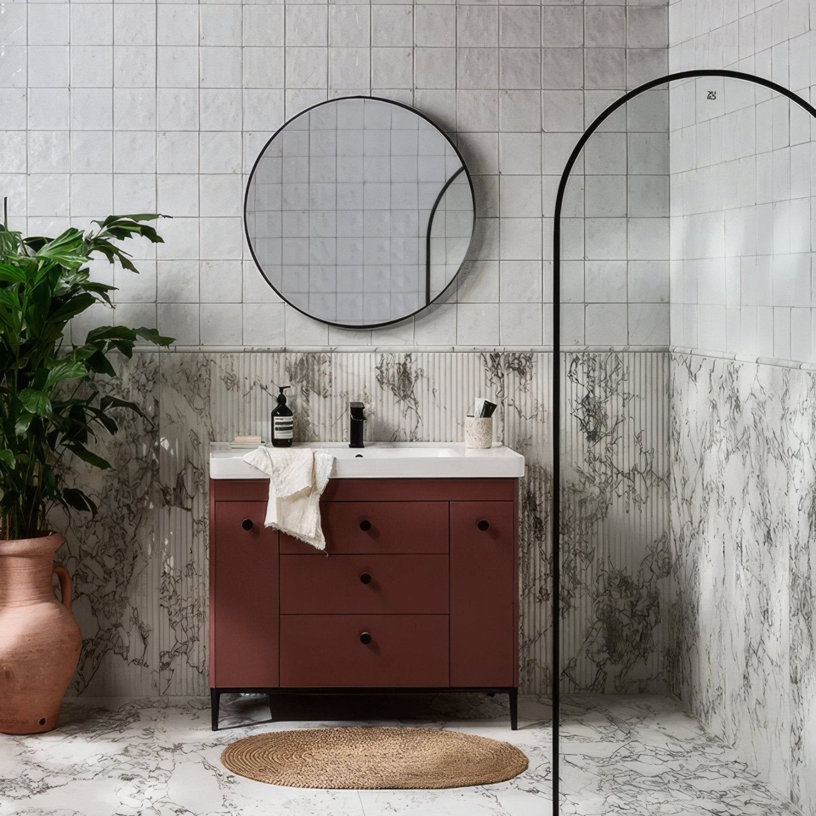 Rust-colored vanity with black round knobs and white arte italiano blanco porcelain countertop