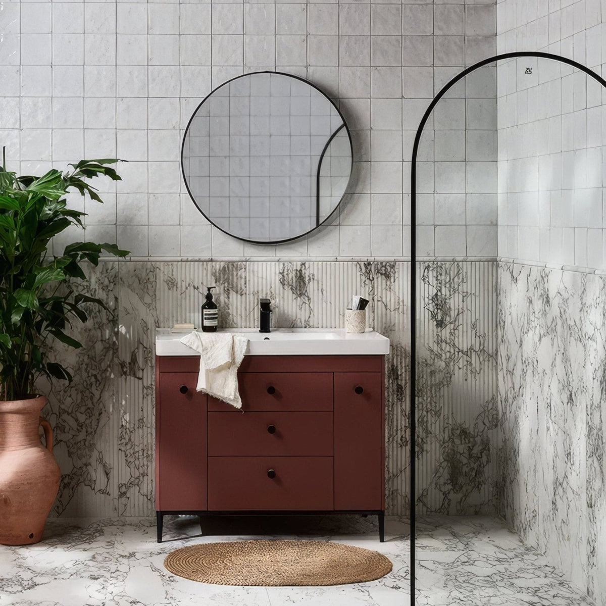 Rust-colored vanity with black round knobs and white arte italiano blanco porcelain countertop