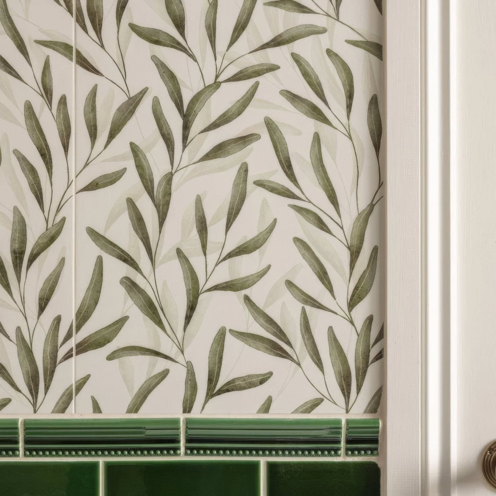 The arts & crafts willow 60x30cm wallpaper features olive green leafy branches on off-white with a green tile border
