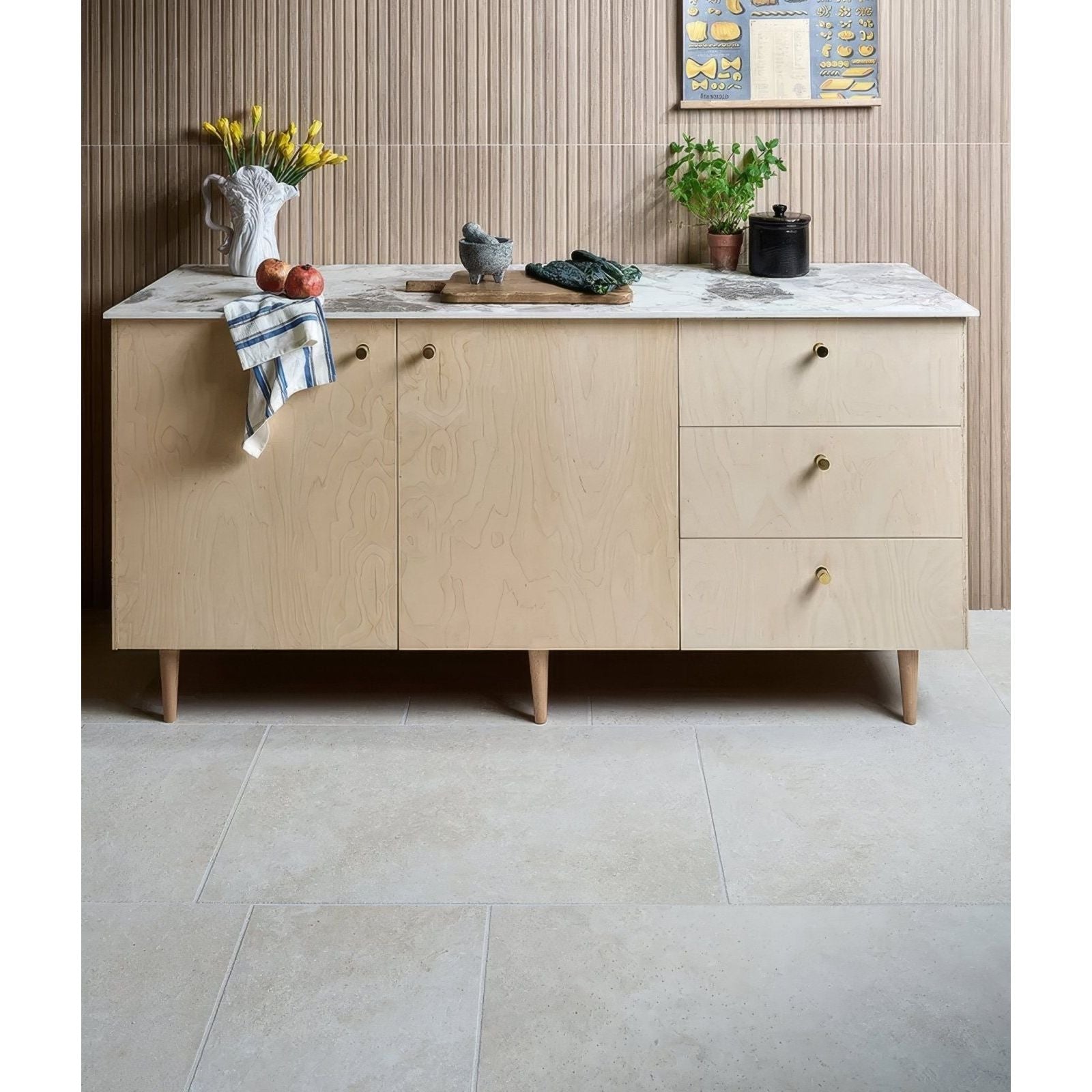 Light wood grain sideboard with marble countertop and brass handles featuring ascoli porcelain avorio 40 x 60cm tile