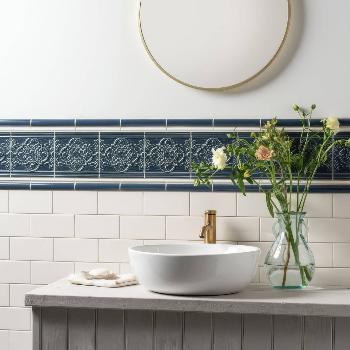White ceramic vessel sink with gold-toned faucet paired with ascot blue sigma moulding trim