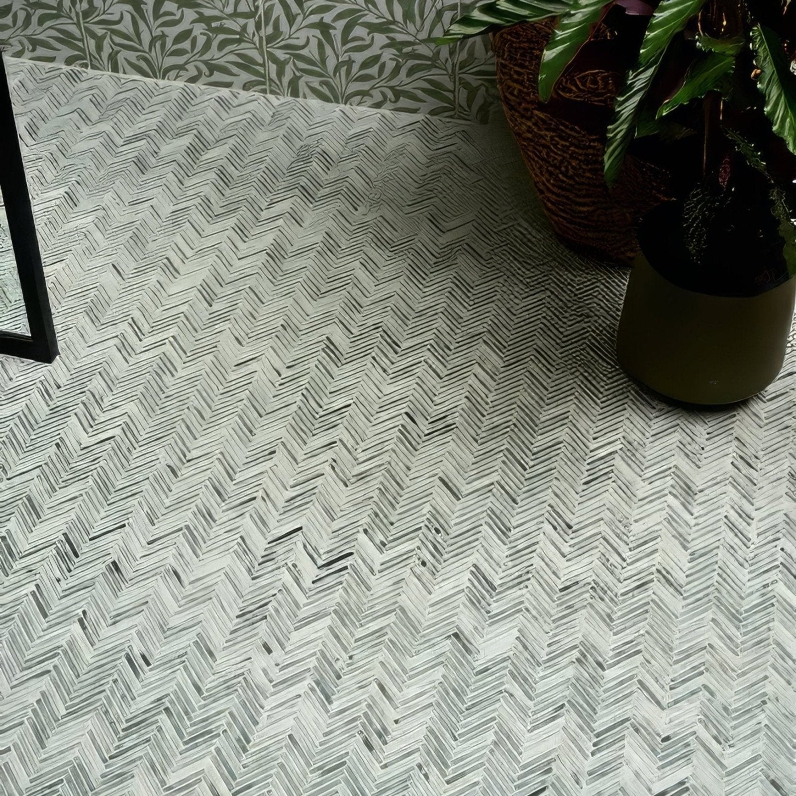 Herringbone-patterned athens mint marble mosaic tile floor in white and gray tones for elegant interiors