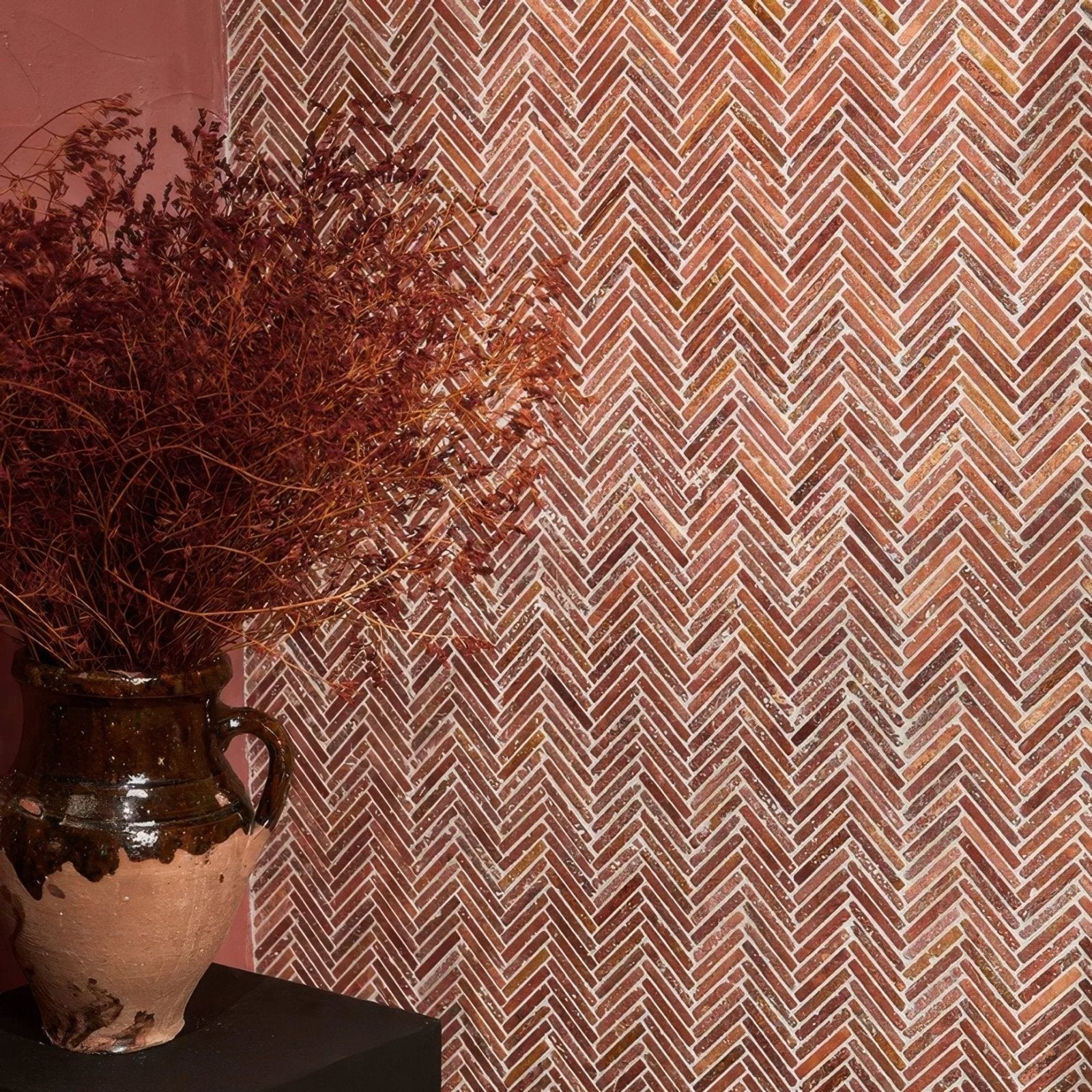 Earthenware ceramic vase with dark glazed handle and rustic texture in athens rosso travertine mosaic style