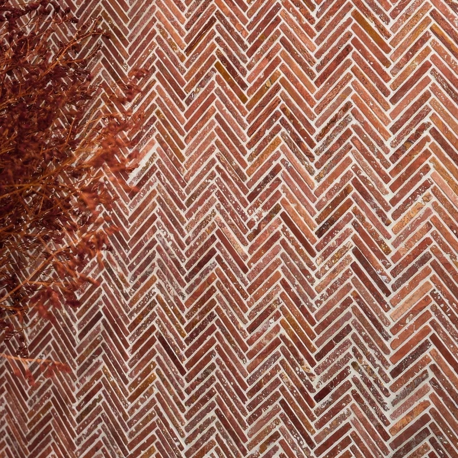 Athens Rosso travertine mosaic with reddish-brown bricks laid in a herringbone pattern with white mortar
