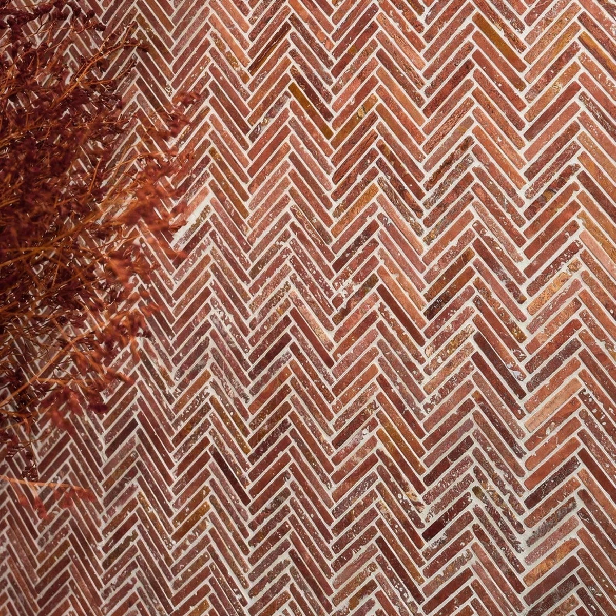 Athens Rosso travertine mosaic with reddish-brown bricks laid in a herringbone pattern with white mortar