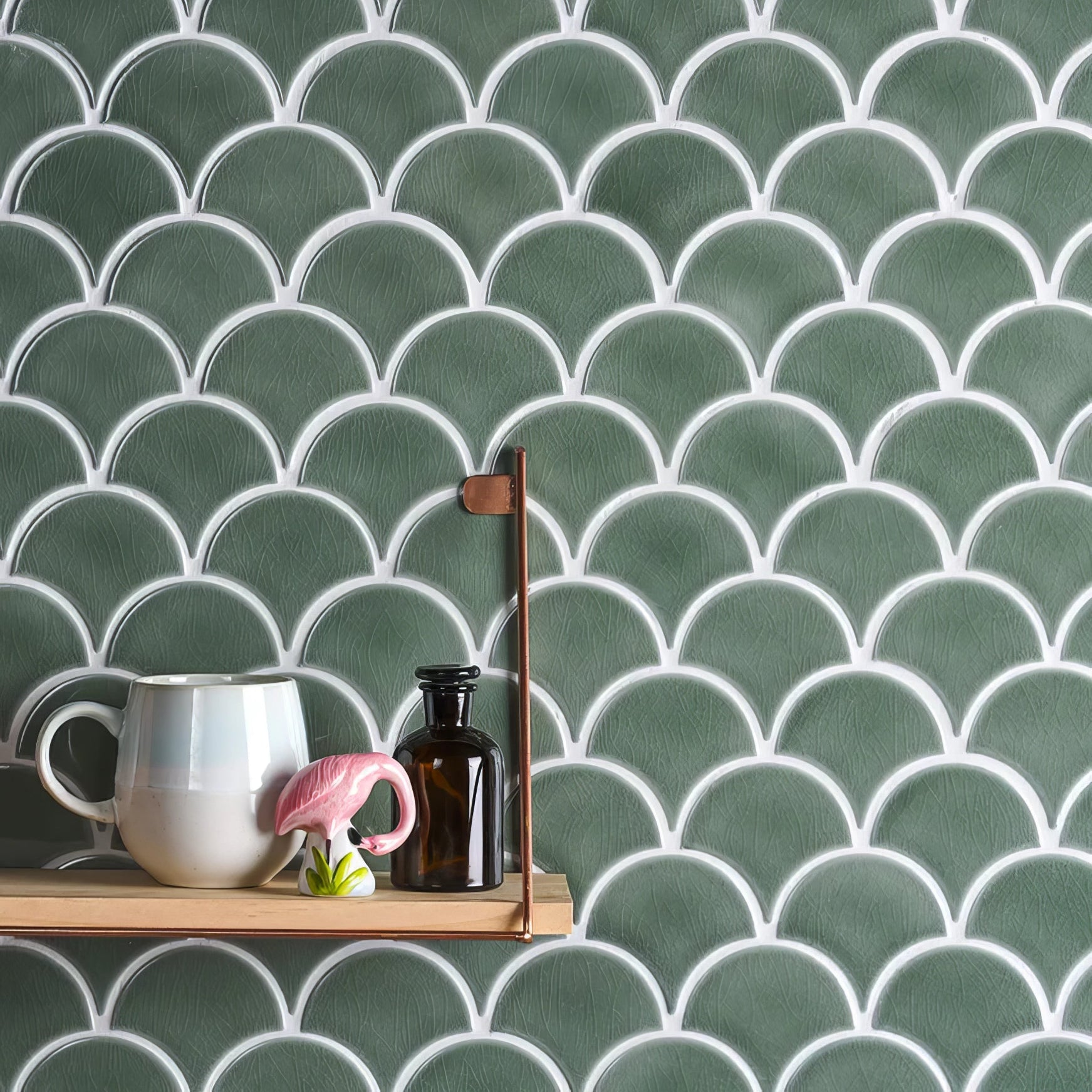 Green scalloped atlantis porcelain mosaic thyme tiles with white grout create a textured fish scale wall pattern