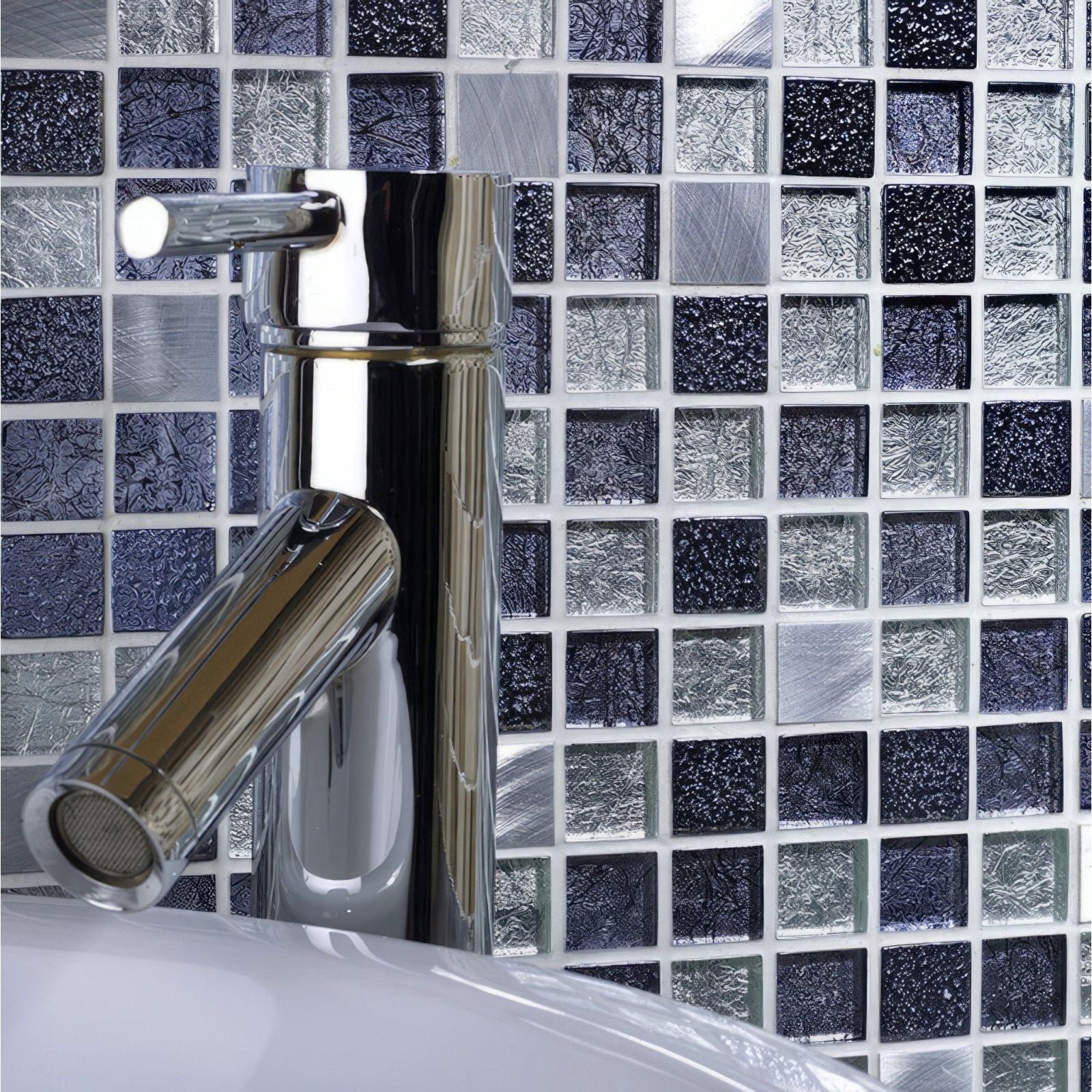 Atlas Fusion Glass & Metal Mix Mosaic dark blue and silver glass and metal mosaic behind a chrome bathroom tap