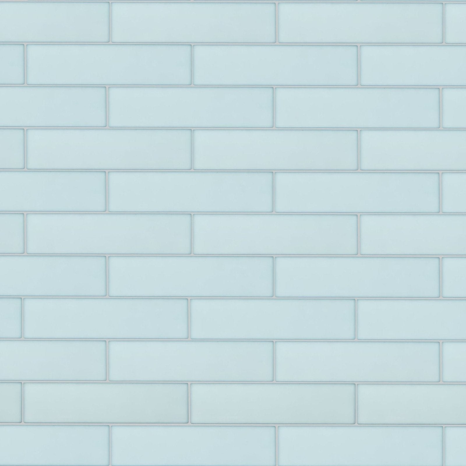 Light blue rectangular glass subway tiles arranged in a classic brick pattern from aurora salla brick glass mosaic