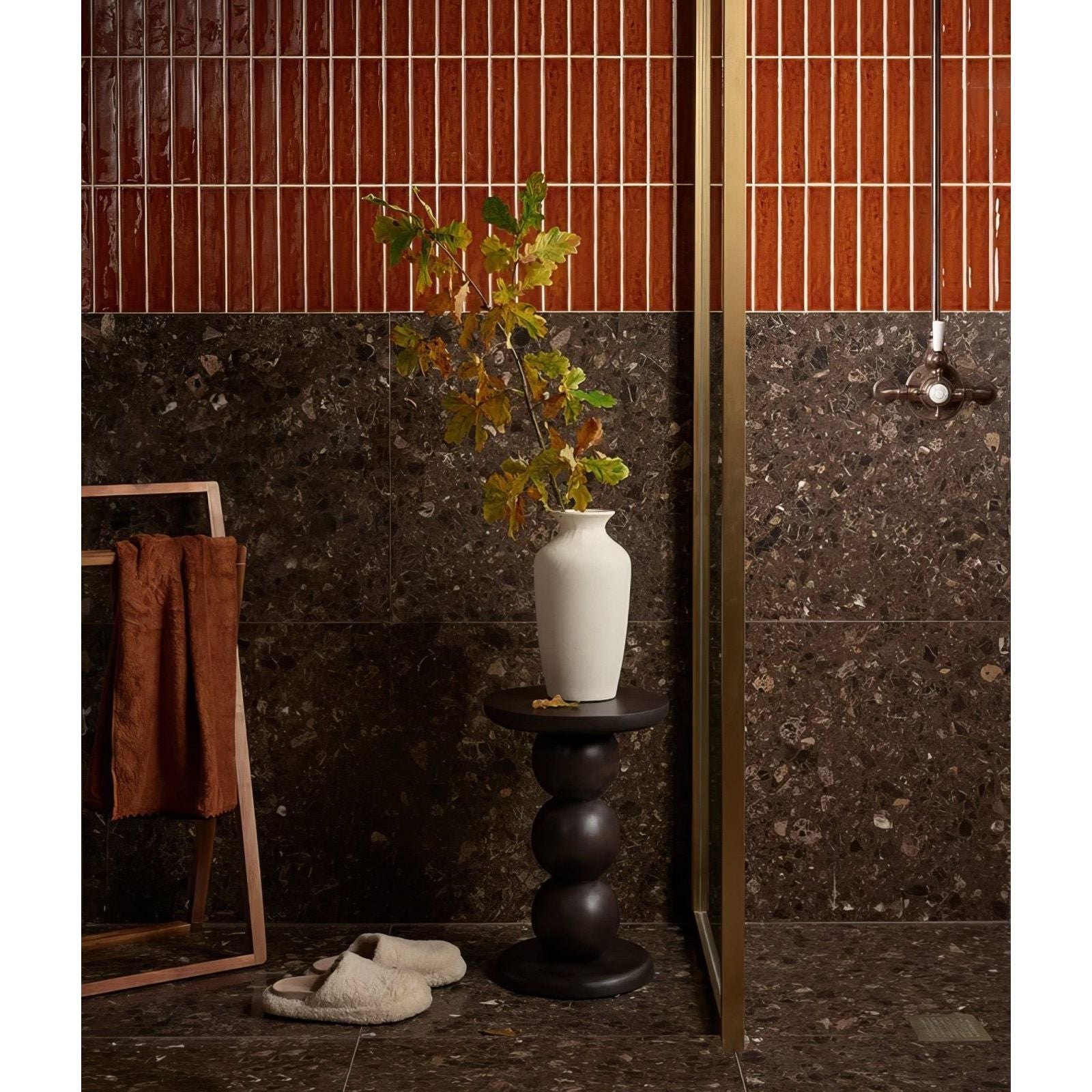 White ceramic avebury vase with slender neck rounded body holding greenery in burnt caramel finish