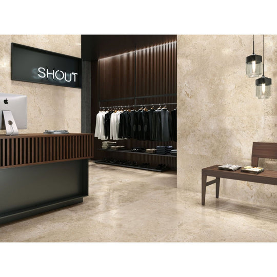 Baltimore 1821 Caramel Polished beige marble-effect tiles on the walls of a minimalist retail interior with dark wood accents