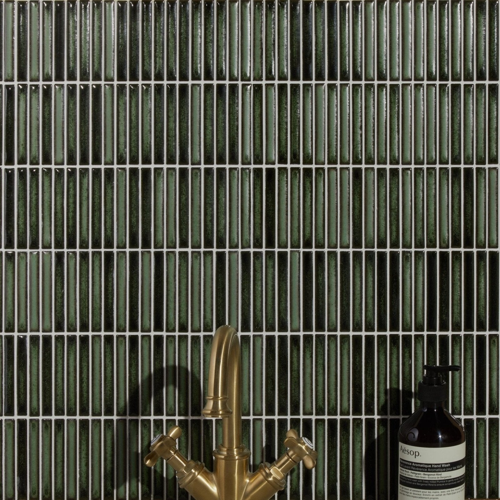 Bamboo Lustre Porcelain Mosaic Forest dark green ribbed porcelain mosaic behind a brass tap