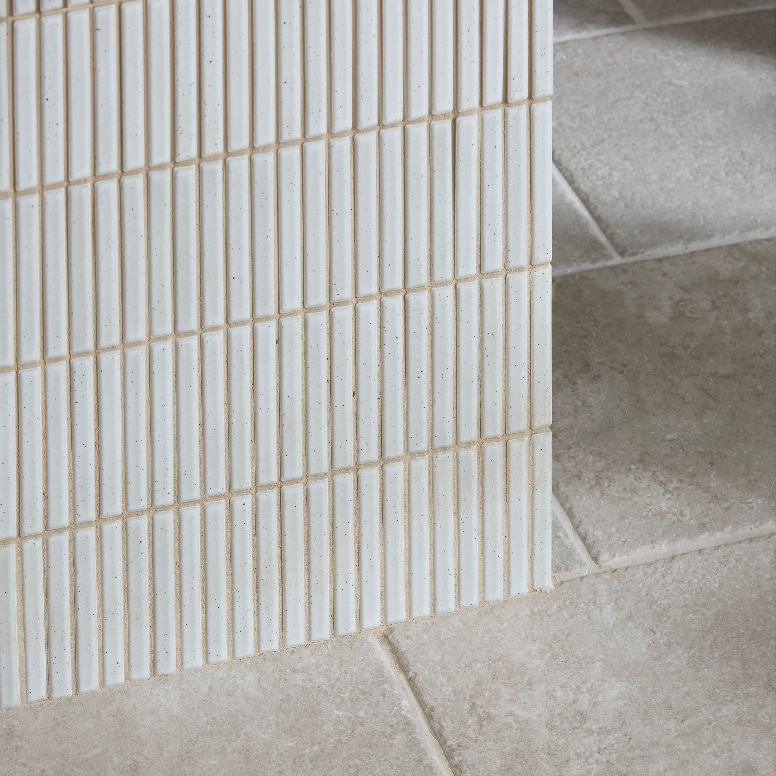 White rectangular ceramic mosaic tiles with subtle speckles arranged in vertical grid pattern bamboo porcelain mosaic vintage white