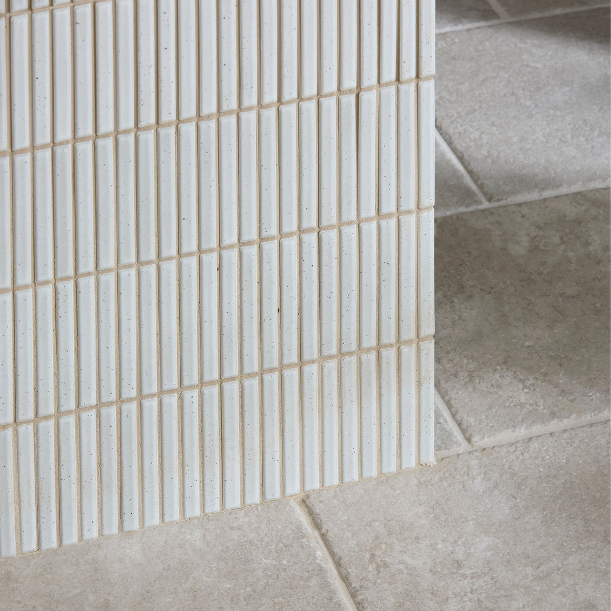 White rectangular ceramic mosaic tiles with subtle speckles arranged in vertical grid pattern bamboo porcelain mosaic vintage white