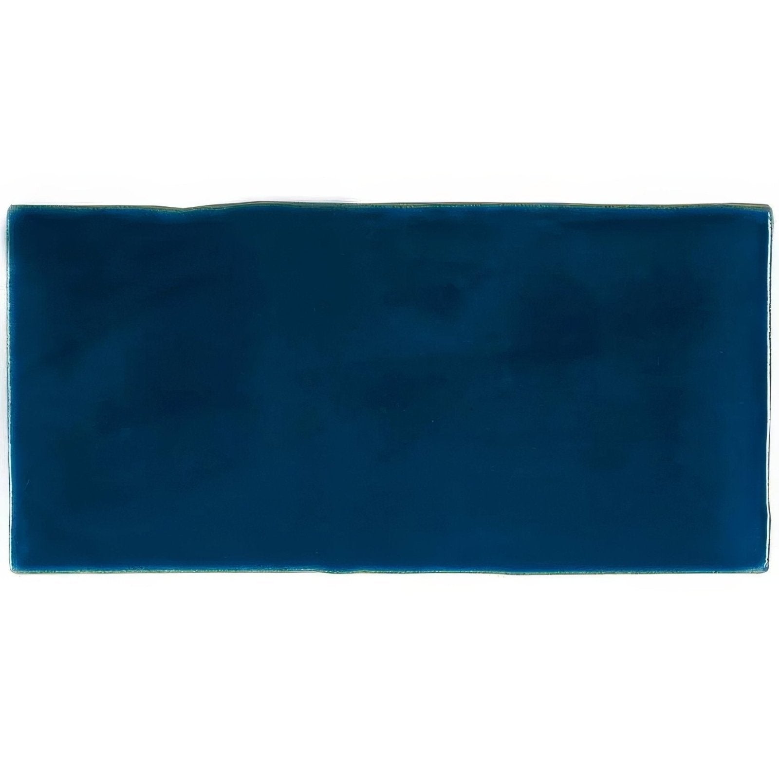 Bastille brick tile is a rectangular navy blue ceramic tile with a smooth glossy finish and slightly uneven edges