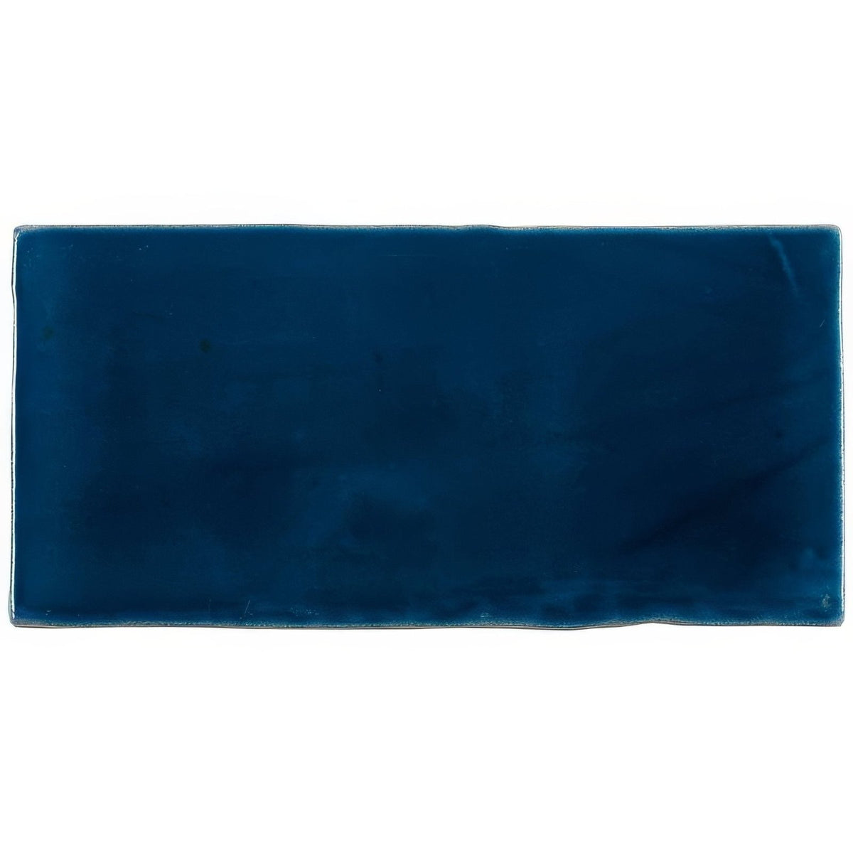 A rectangular deep navy blue ceramic bastille half tile wall tile with a smooth glossy finish