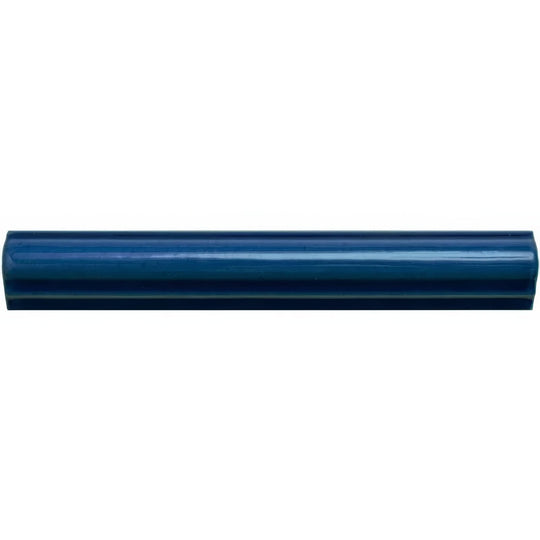 A glossy navy blue ceramic bastille ogee moulding tile with smooth rounded edges and subtle gradient finish