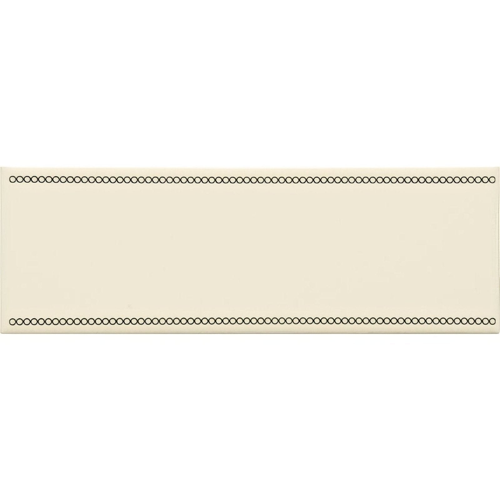 Cream-colored rectangular tile with black circular dot beaded border in charcoal grey on county white background