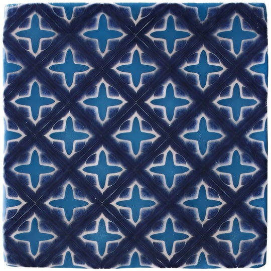 Behen on truffle blue ceramic tile with white quatrefoil pattern set within intersecting diagonal lines