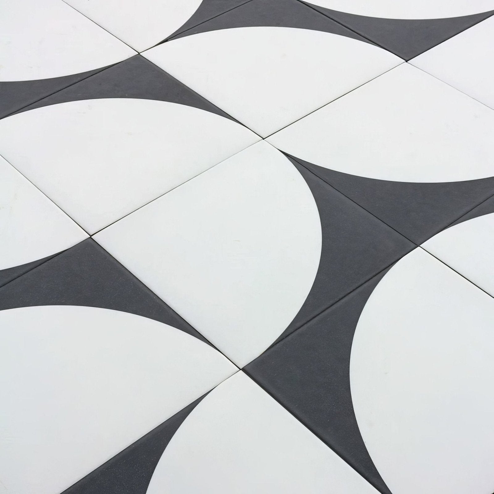 Black and white geometric patterned floor tiles with curved interlocking shapes bert and may arco old iron porcelain