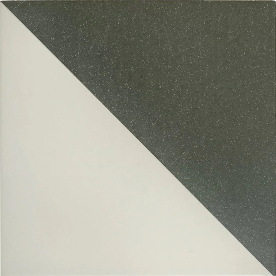 A sleek minimalist Bert & May black Alalpardo porcelain tile with a diagonal split of smooth white and textured dark gray surfaces