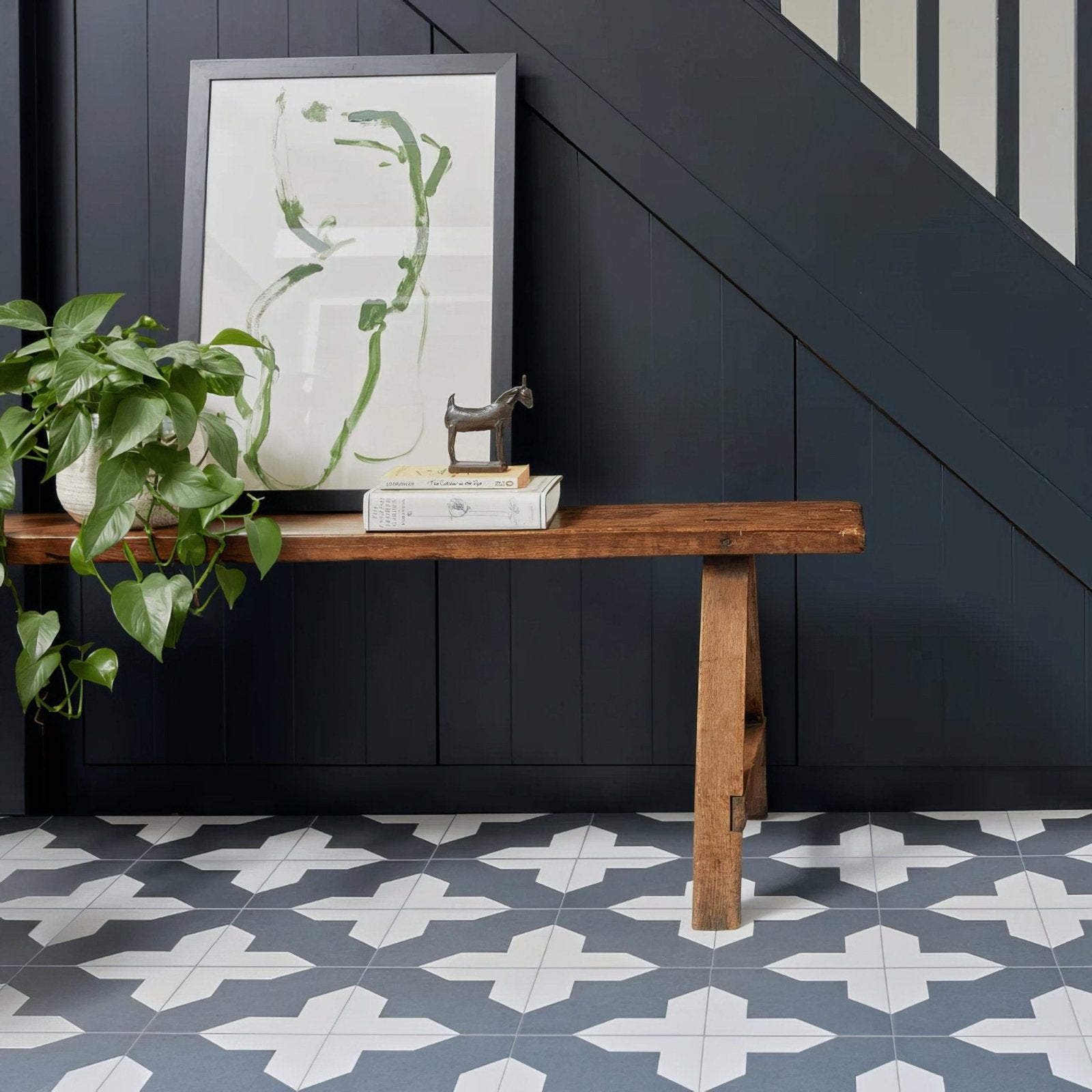 Rustic wooden bench with natural finish and sturdy legs paired with bert & may black crosses porcelain tile