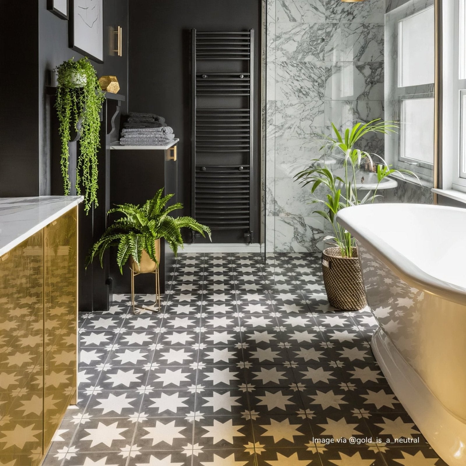Gold-finished freestanding porcelain bathtub with glossy curved surface and elegant classic design from bert & may black pradena