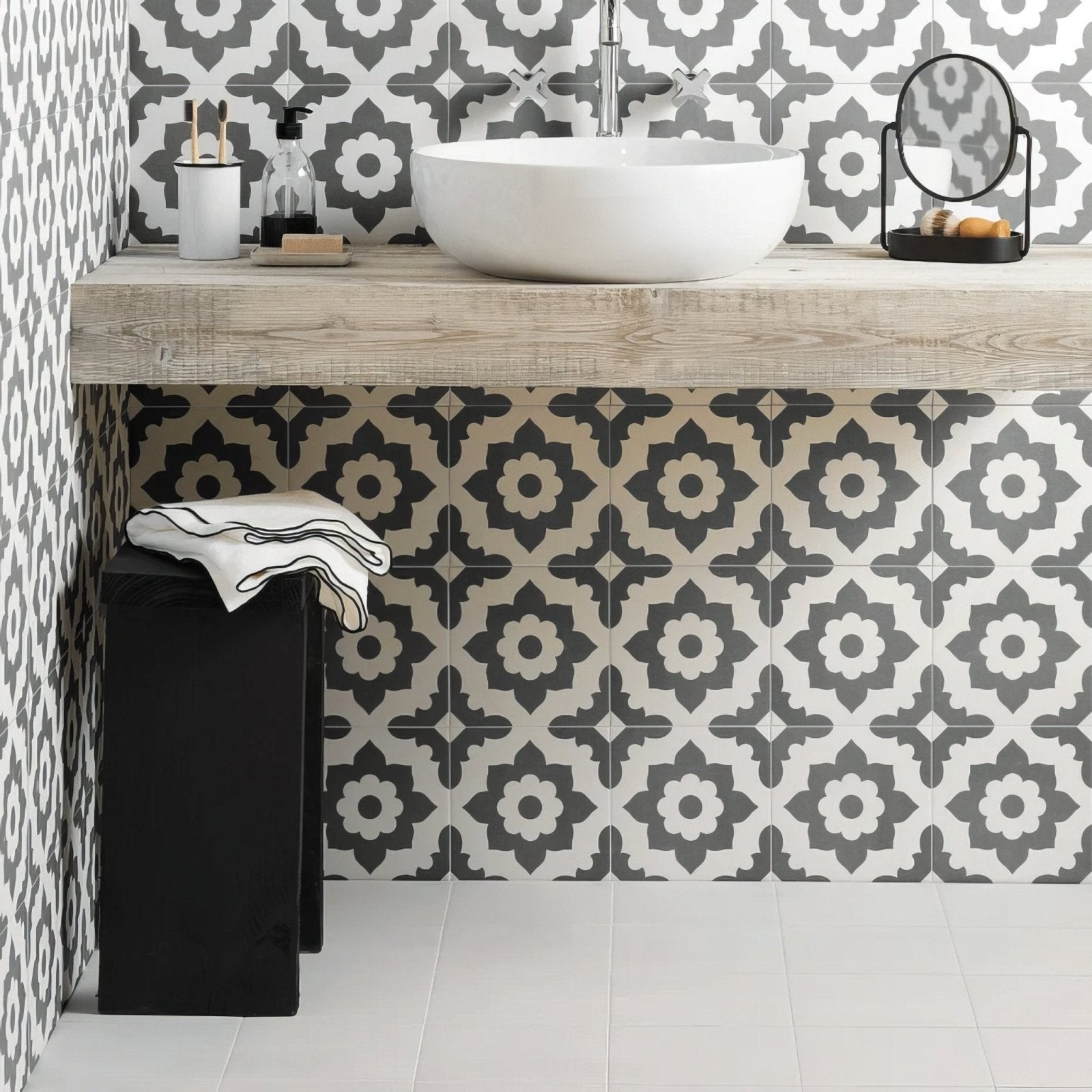 White ceramic vessel sink with a sleek modern design on rustic wooden countertop from Bert and May Black Santona porcelain