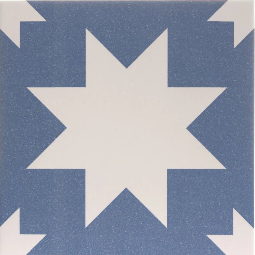 Blue and white star-patterned porcelain tile with a speckled finish from bert and may pradena collection
