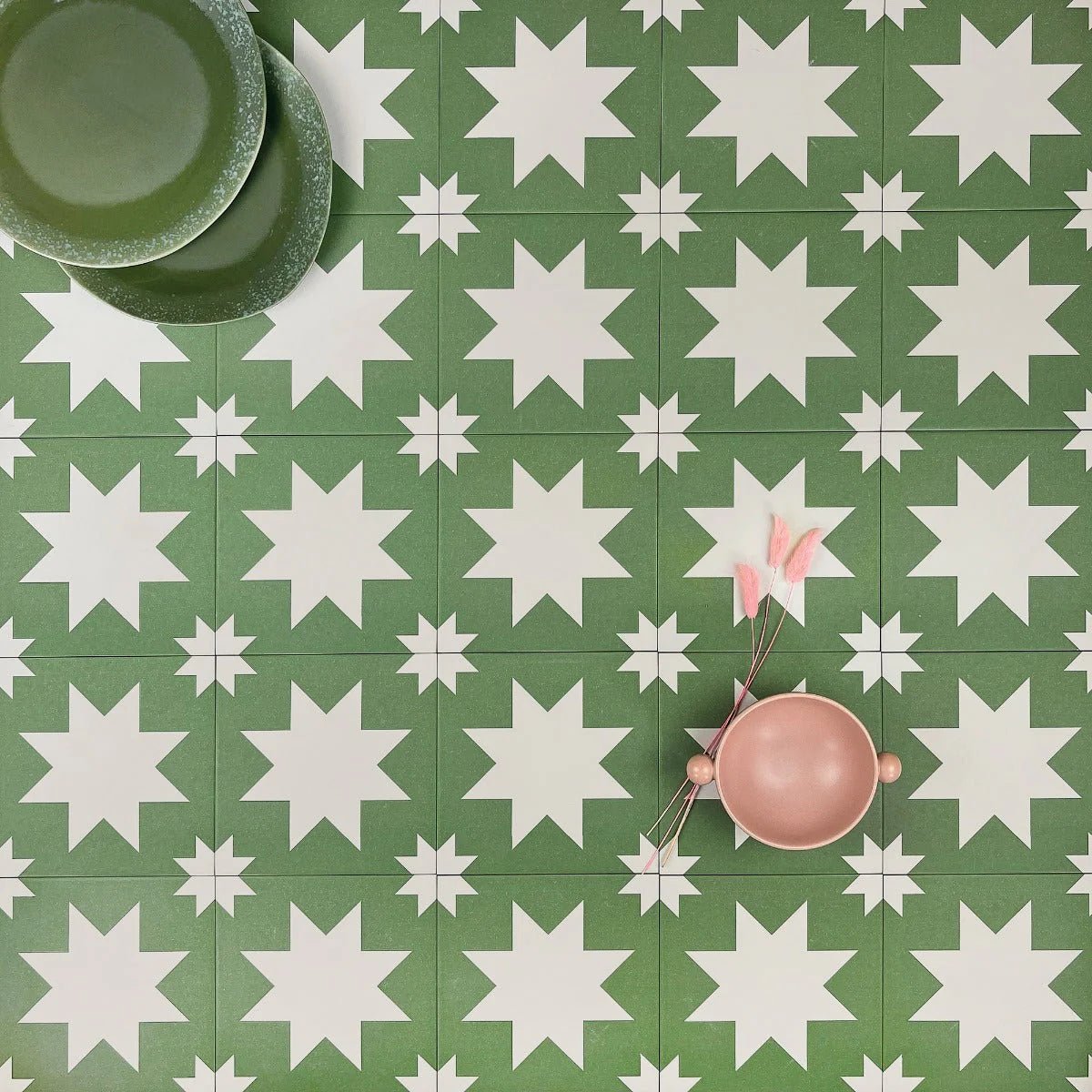 Pink ceramic bowl with wooden handles and pink feathers beside it from bert and may green pradena porcelain collection