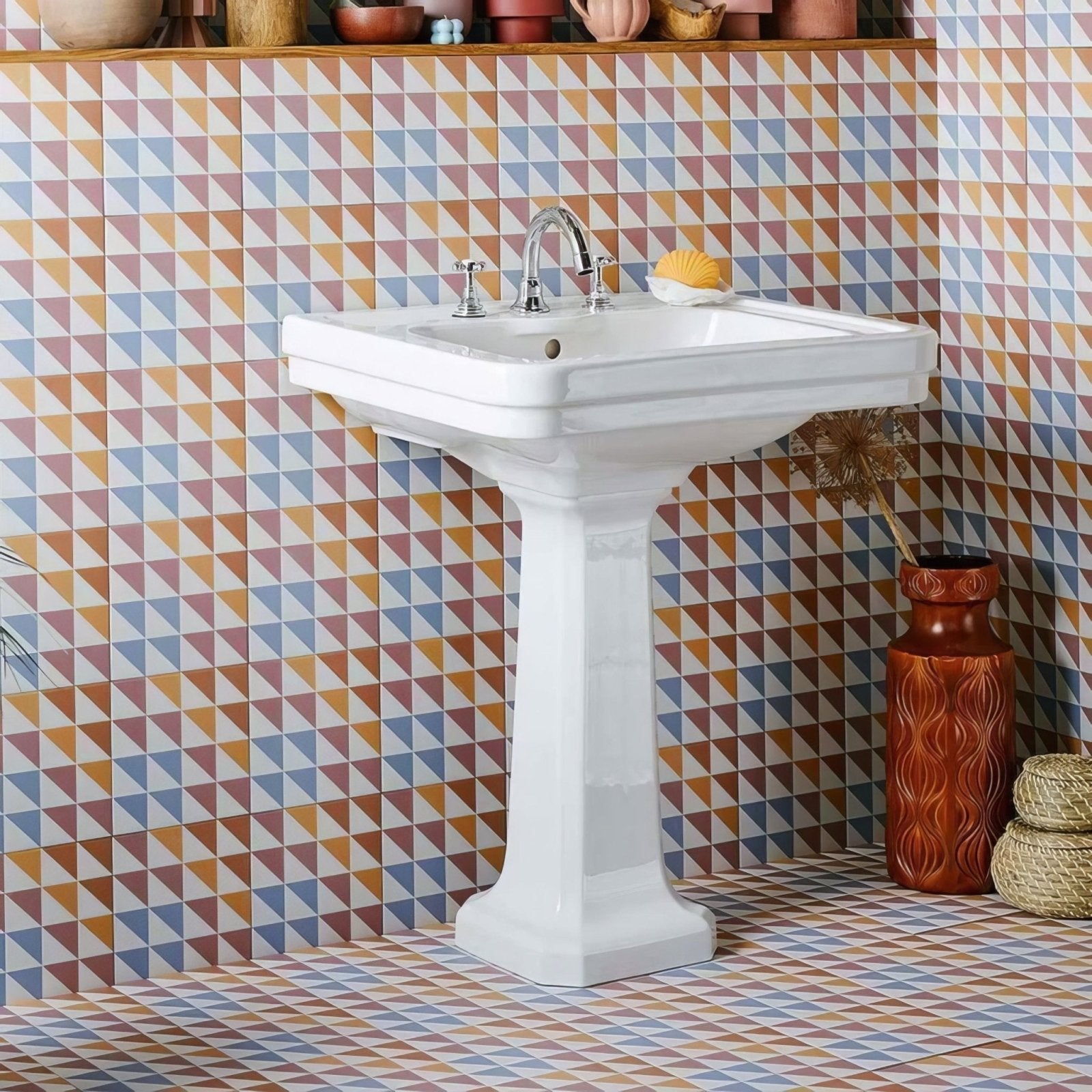 White ceramic pedestal sink with chrome faucet and handles paired with bert and may soho majadas porcelain tile
