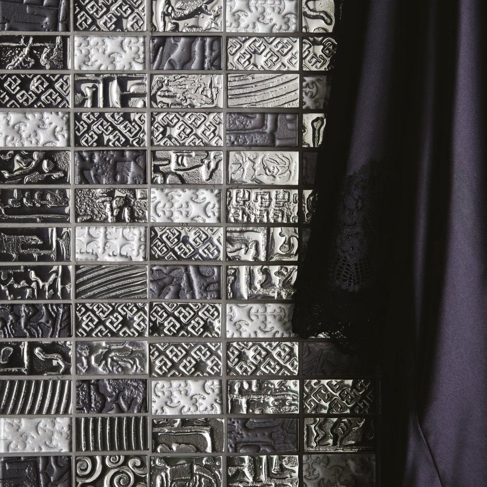 Black and white textured mosaic tile wall with intricate embossed patterns from the bihar mixed mosaic collection