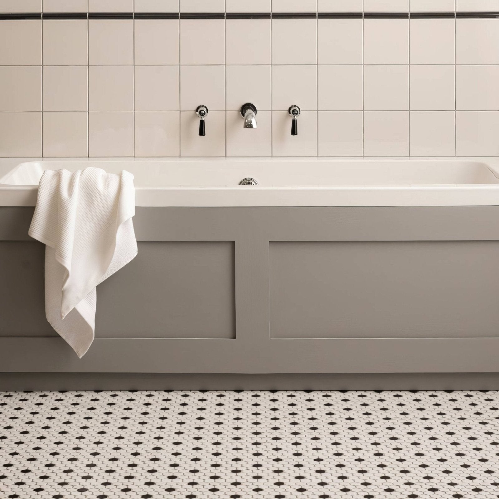 Black and White Honeycomb Floor Mosaic black and white hexagonal mosaic flooring with a grey bathtub and black taps