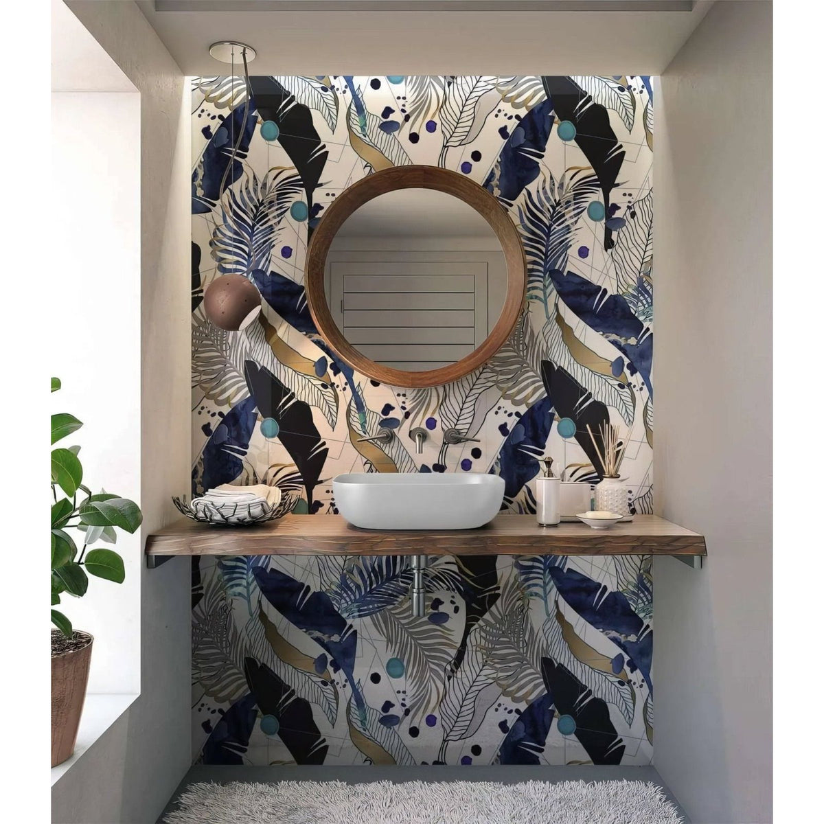 Round wooden-framed mirror above white vessel sink in black gold navy leaves feathers shower panel bathroom setup