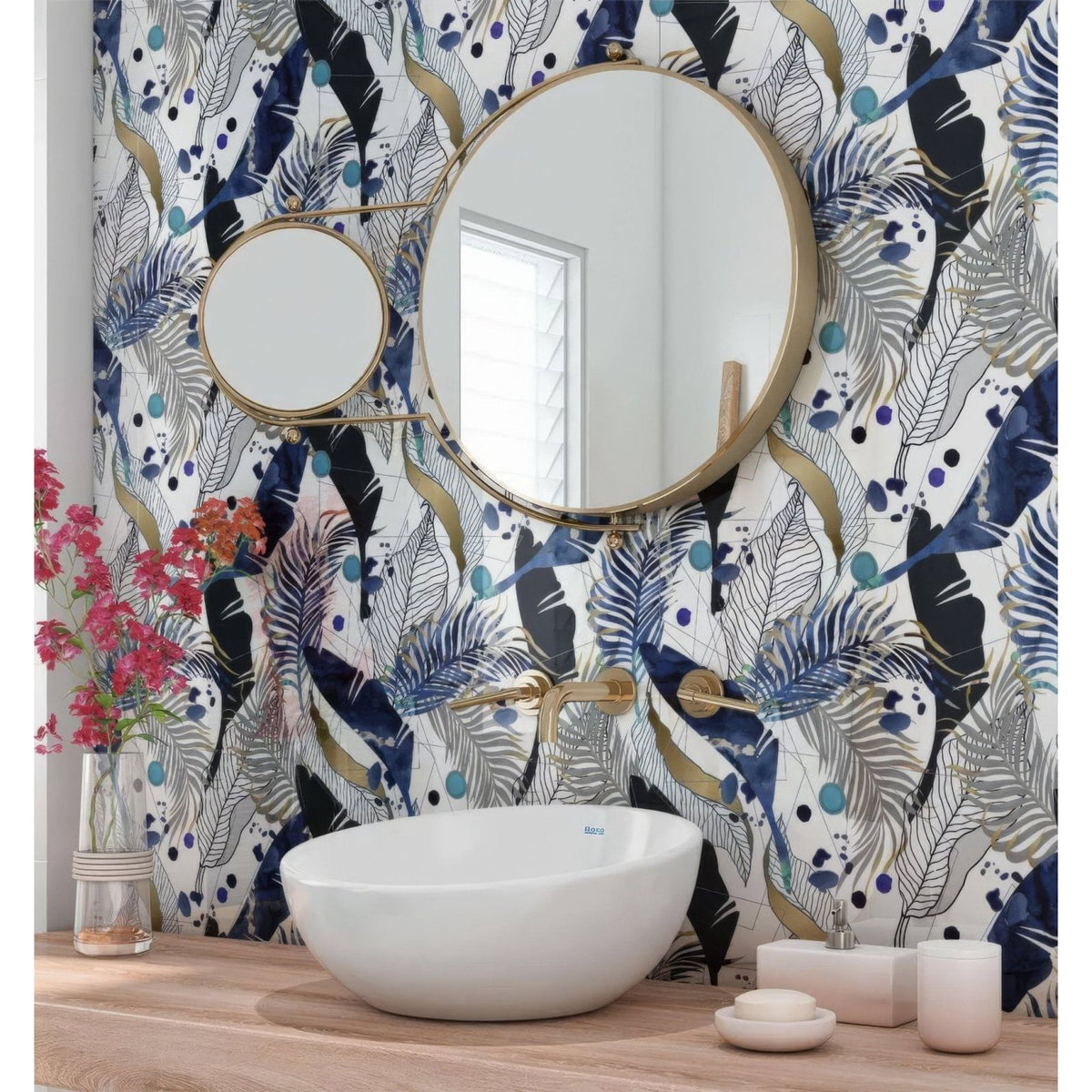 White ceramic bowl sink with gold-toned faucet and fixtures beside black gold navy leaves feathers shower panel