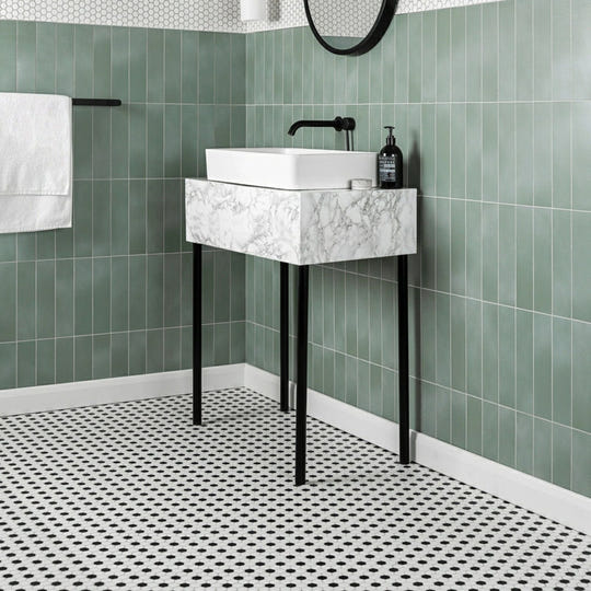 Black & White Honeycomb Floor Mosaic black and white hexagonal mosaic flooring beneath a marble-effect sink with black metal legs