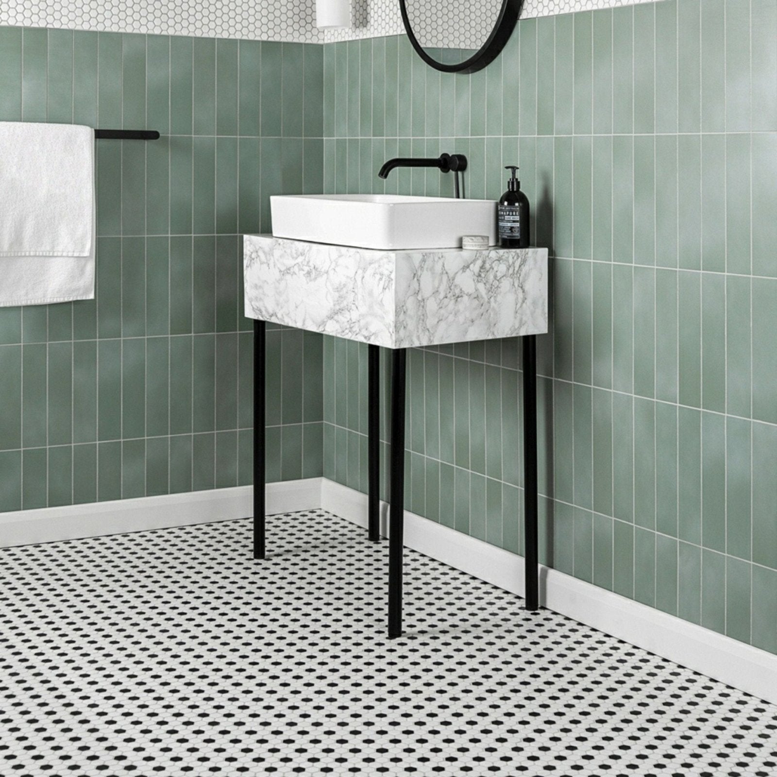Black & White Honeycomb Floor Mosaic black and white hexagonal mosaic flooring beneath a marble-effect sink with black metal legs