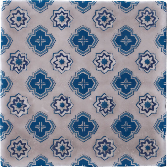 Blue and white patterned ceramic tile with geometric starburst designs from bourron on truffle collection