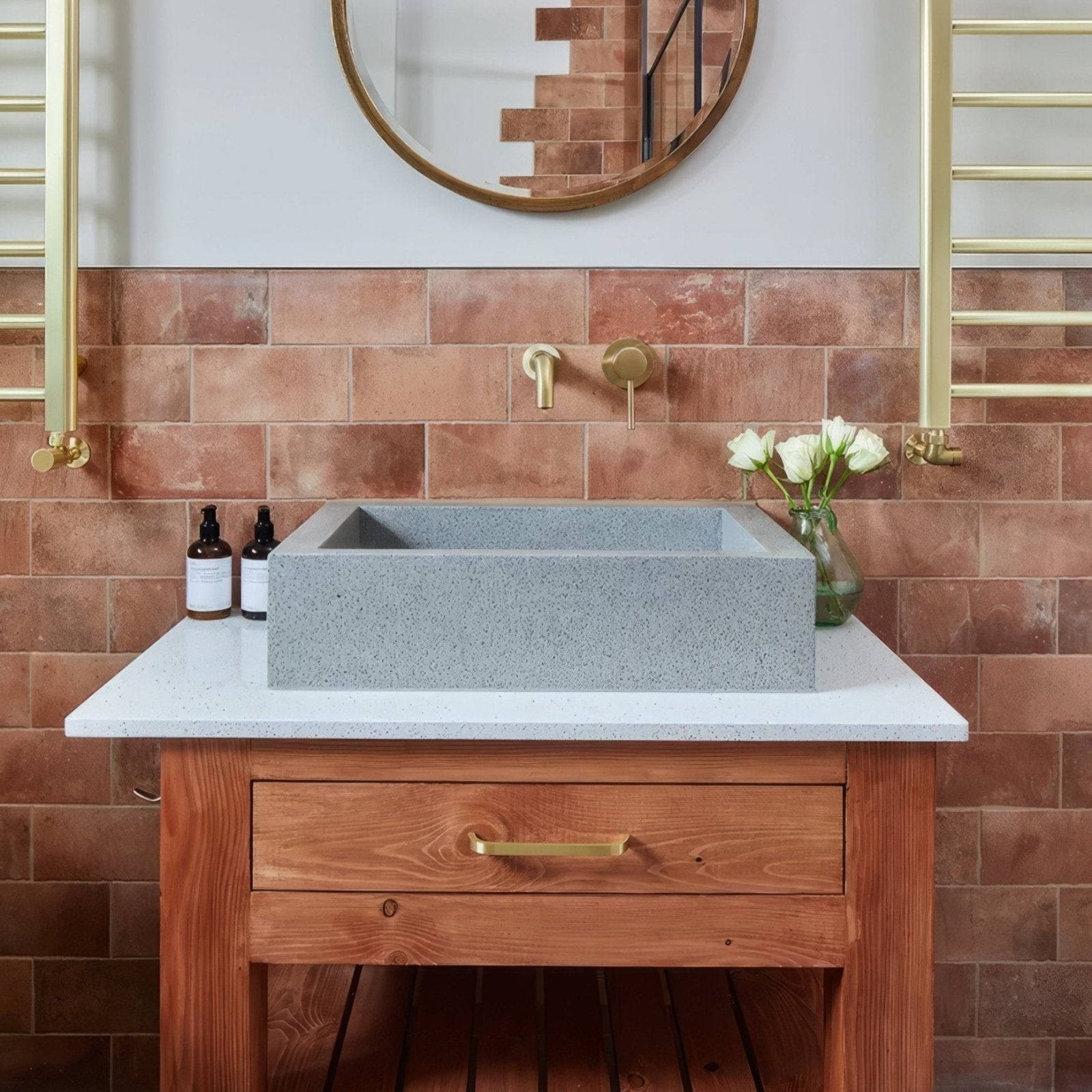 Gray concrete rectangular brewhouse porcelain brick sink with subtle speckled texture in white countertop and wooden cabinetry