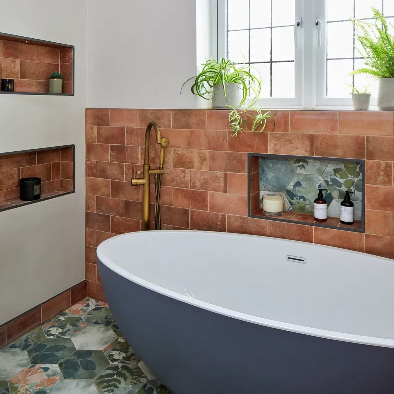 Modern freestanding bathtub with a sleek matte dark gray finish and smooth rounded contours featured in Brewhouse Porcelain Brick