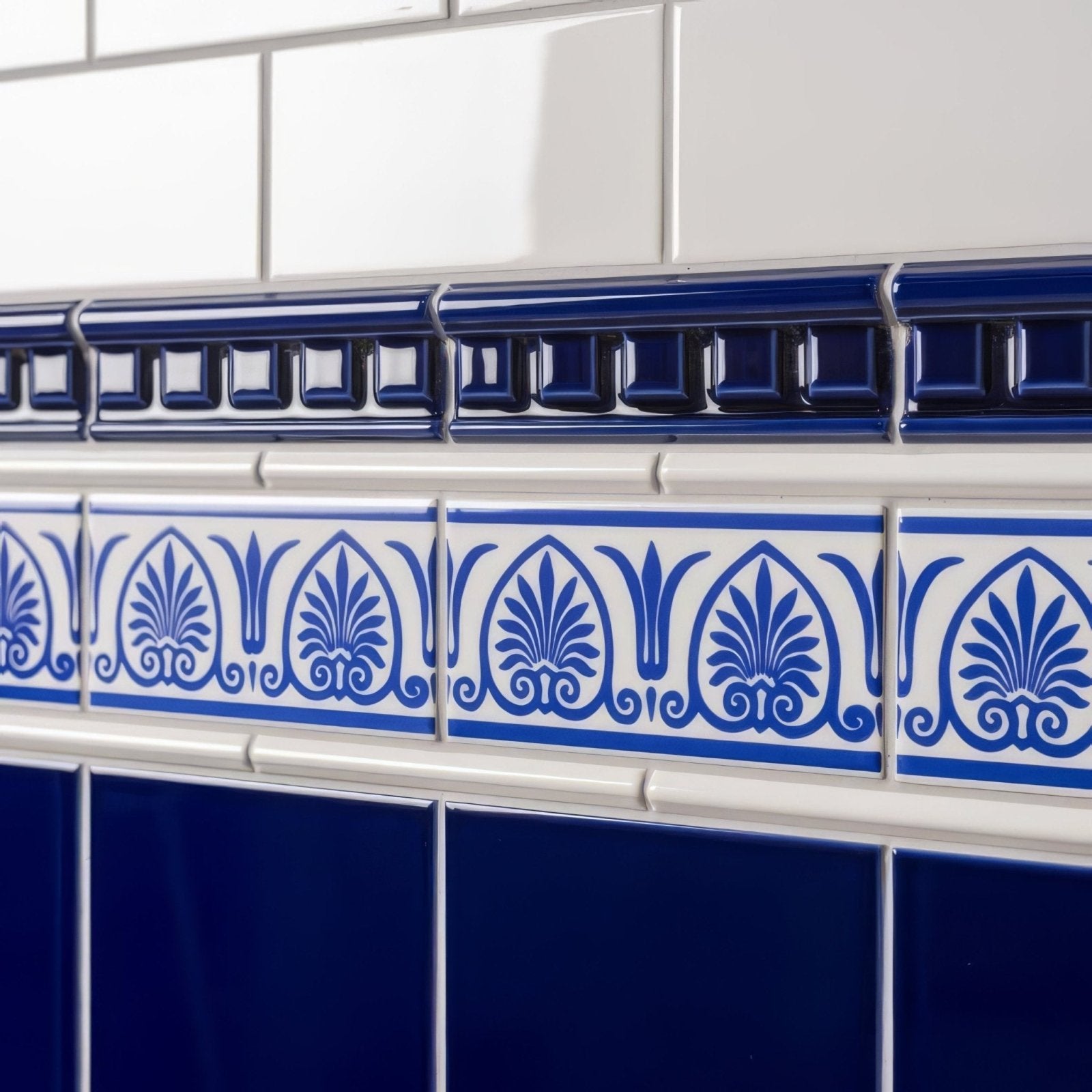 Blue and white ceramic tile border with ornate foliate patterns for brilliant white omega moulding trim