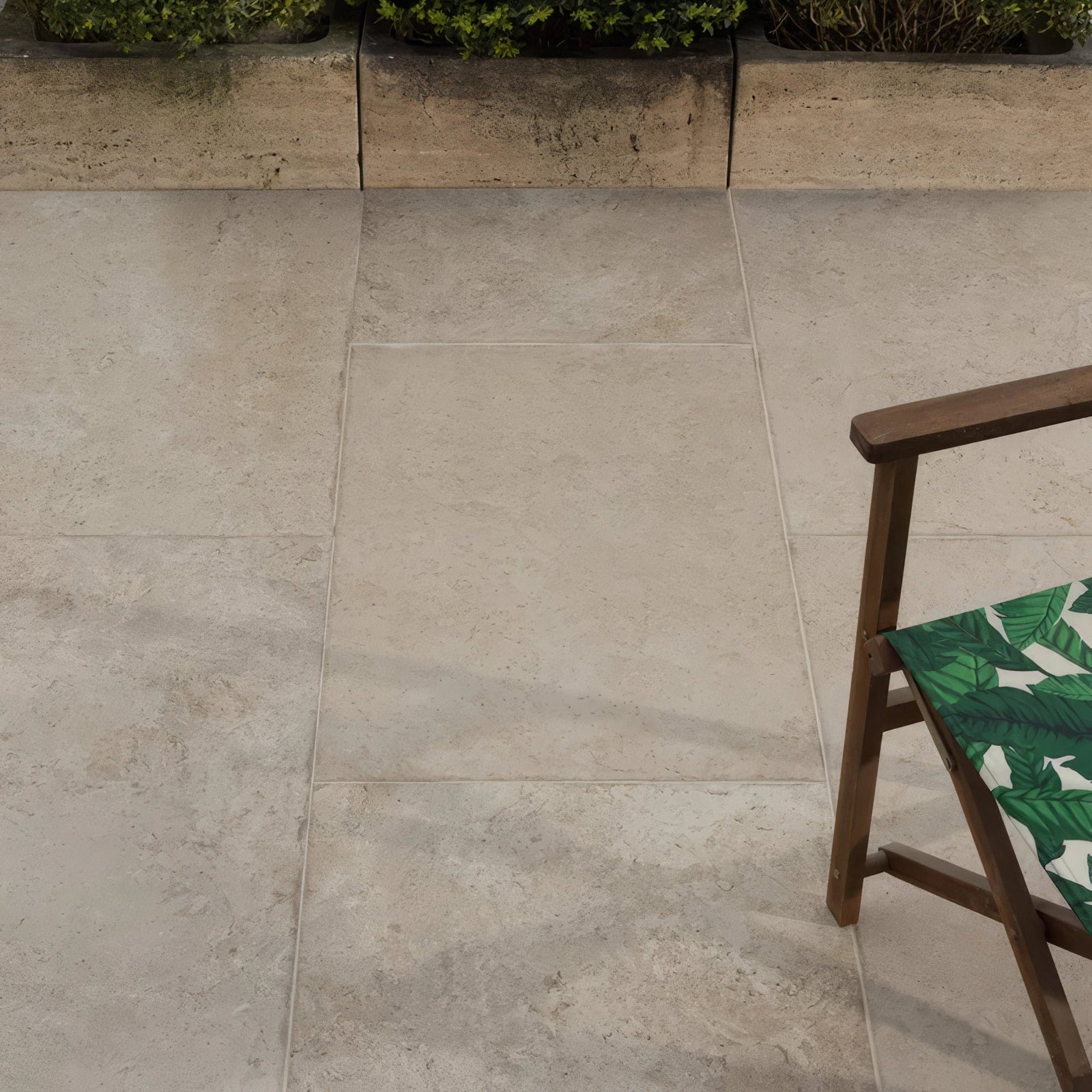 Beige brit stone burford porcelain paving tiles with subtle natural texture and light gray grout lines on patio