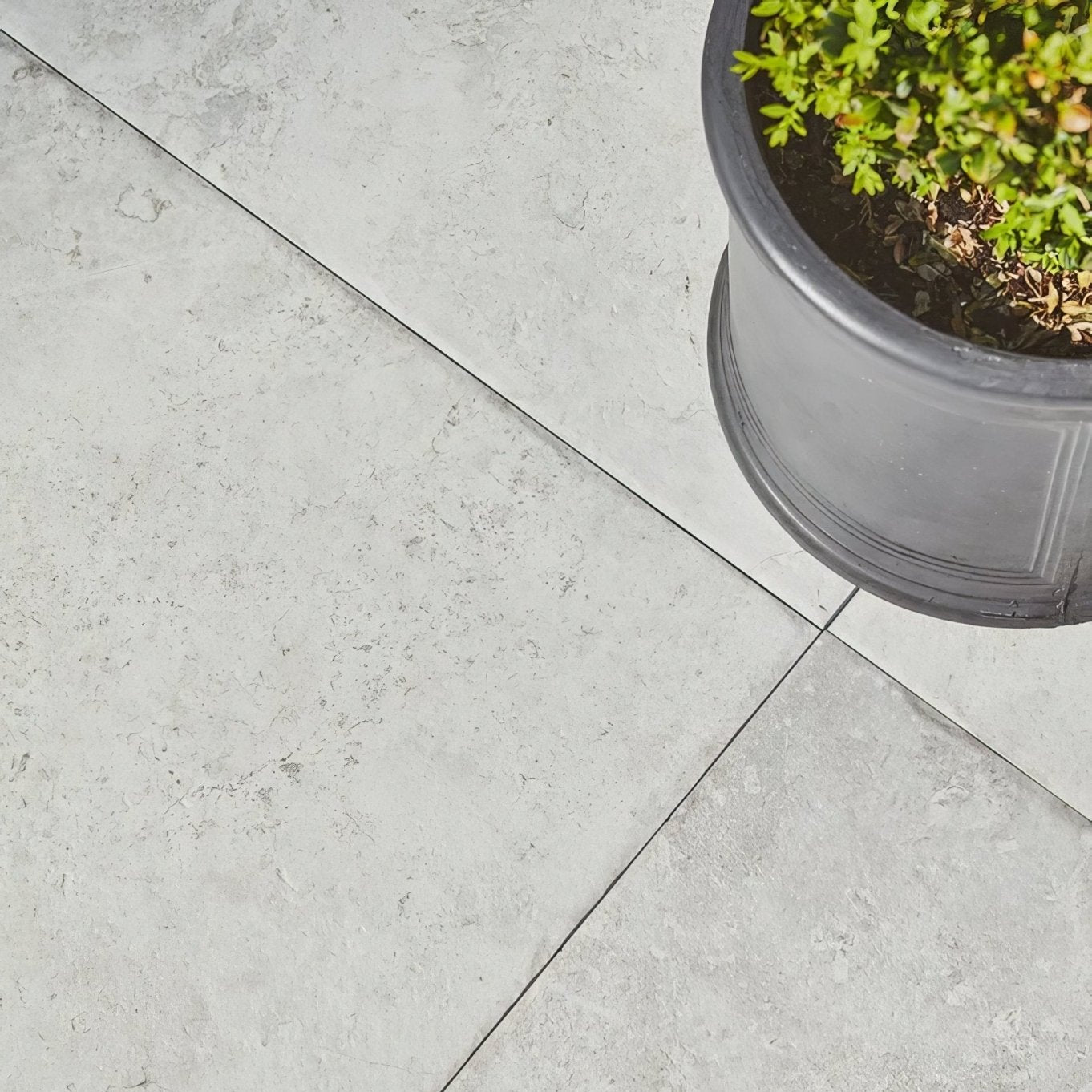Brit stone minster porcelain paving gray stone-effect patio tiles with subtle texture and dark grout lines