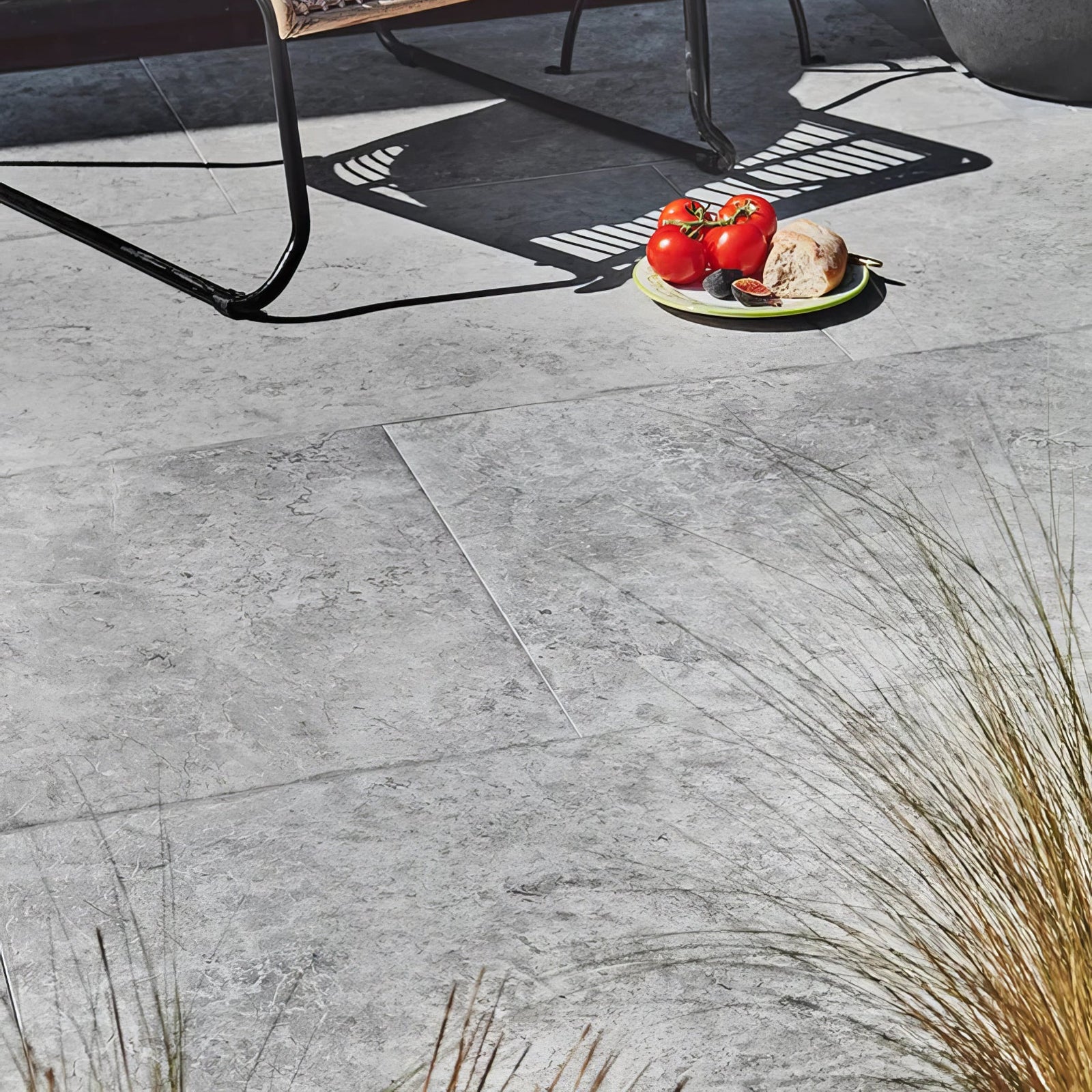 A light gray Brit Stone Pennant porcelain paving tile with textured stone surface subtle veining and matte finish