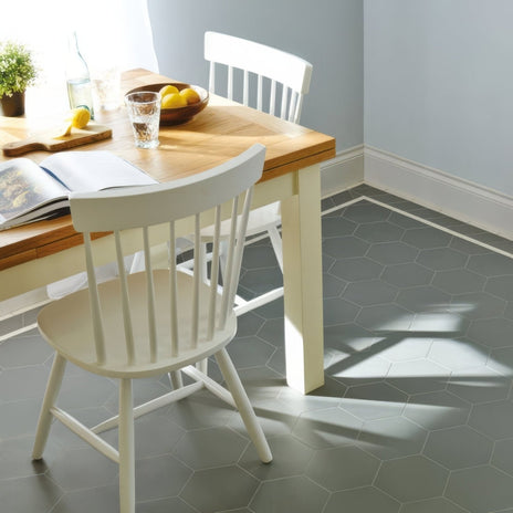 White wooden dining table with light wood top and white spindle-back chairs from buckfastleigh revival grey set