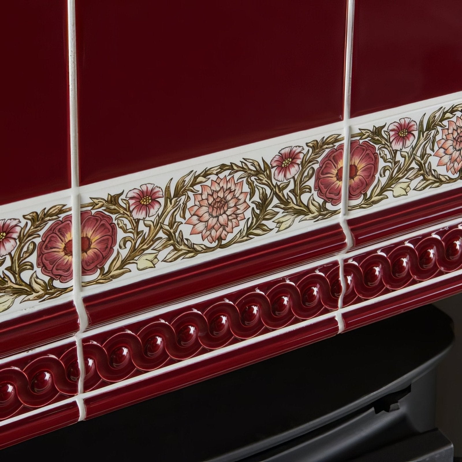 Burgundy omega moulding red ceramic tiles with decorative pink and maroon floral border and green leaves ornate pattern