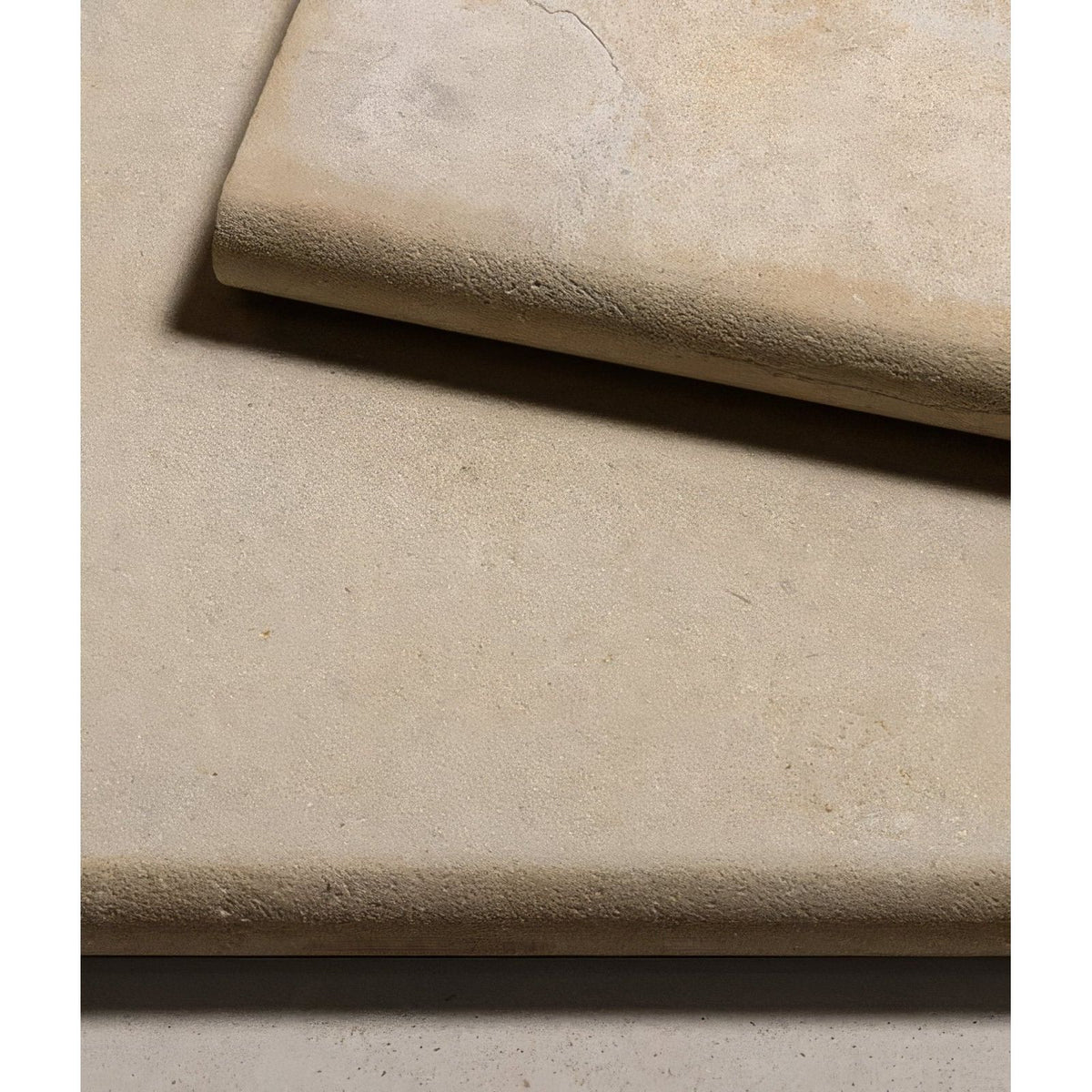 Beige textured stone tiles with a subtle natural finish from buscot limestone etched bullnose coping collection