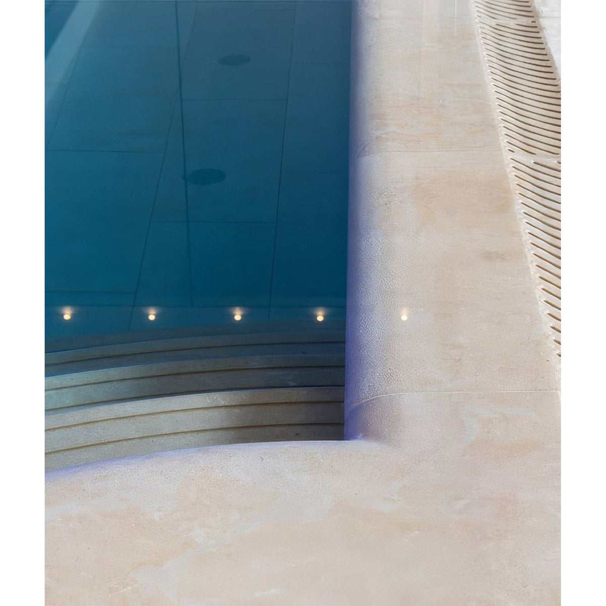 Buscot limestone etched bullnose coping beige stone pool edge with integrated drainage slats and curved steps
